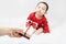 Cute asian baby in red bodysuit get gift box sitting on white blanket at home.Give Year present to child,kid,toddler.Concept