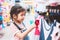 Cute asian child girl choosing dresses in clothes department