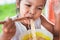 Cute asian child girl eating delicious instant noodles