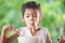 Cute asian child girl eating delicious instant noodles with fork