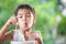 Cute asian child girl eating delicious instant noodles with fork