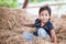 Cute asian child girl having fun to play with hay stack