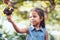 Cute asian child girl picking the red grapes harvested