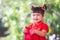 Cute asian child girl smiling and getting money in red envelope and wishing you a happy in Chinese New Year