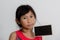 Cute Asian girl holding blank blackboard