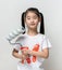 Cute asian girl holding paint roller