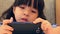 Cute Asian Girl Playing Smart Phone