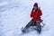 Cute Asian girl is riding a sledge on a high speed