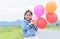 cute asian girl smile and holding balloon,