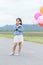 Cute asian girl smile and holding balloon,