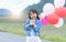 Cute asian girl smile and holding balloon,