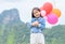 Cute asian girl smile and holding balloon,