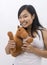 Cute asian girl smiling with a teddy horse