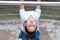 Cute Asian kid hanging on pull-up bar at playground in the village park. Sport outdoor activity for kid