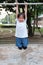 Cute Asian kid hanging on pull-up bar at playground in the village park. Sport outdoor activity for kid