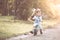 Cute asian little child boy having fun to ride his balance bike