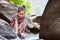 Cute asian little child girl playing paper boat in the riverside