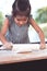 Cute asian little child girl prepares a dough for baking cookies