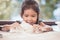 Cute asian little child girl prepares a dough for baking cookies