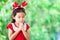 Cute asian little girl in christmas dress closed her eyes