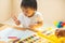 Cute asian little girl is painting the color with fully happiness moment , concept of art and education for kid. closed up kid