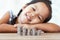 Cute asian little girl playing with coins making stacks of money