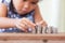 Cute asian little girl playing with coins making stacks of money