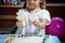 Cute asian little girl is trying to connect couple jigsaw puzzle