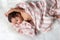 Cute asian newborn baby just wake up in the morning with cozy bed. Adorable newborn asian baby stretching body by raise hand to