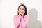 Cute asian presenting her face with hands touching face in v shape, portrait, skincare and cosmetic concept, pink shirt, white
