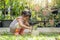 Cute Asian small girl playing with a potted plant