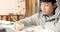 Cute asian teen boy doing your homework at home.