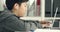 Cute asian teen boy doing your homework with laptop computer at home.