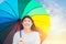 Cute Asian teen happy smile outdoor with rainbow colorful umbrella