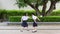 Cute Asian Thai high schoolgirls student couple in school uniform are having fun playing chasing and catching a doll