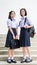 Cute Asian Thai high schoolgirls student couple standing