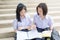 Cute Asian Thai high schoolgirls student couple studying in school