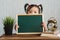 Cute asian toddler holding a blank chalkboard for copy space text