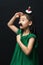 Cute asian woman child with fake mustache and christmas head decoration on black background