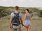 Cute attractive girlfriend and strong, positive boyfriend on a natural background. Young hikers. Romantic trips concept.