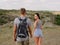 Cute attractive girlfriend and strong, positive boyfriend on a natural background. Young hikers. Romantic trips concept.