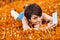 Cute attractive young woman lying in a meadow of orange clover