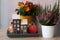 Cute autumn hygge home decor arrangement with pink heather and chrysanthemum flowers.