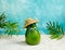 Cute avocado wearing straw hat relaxing on a tropical beach. Summer sale minimal poster