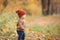 Cute baby in autumn clothes looks to the right. child in knitted hats and jacket in cool weather