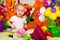 Cute baby in balloon forest