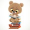 Cute baby bear sitting on a stack of books and reading isolated on white background