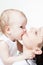 Cute baby biting her mother\'s chin