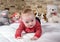 Cute baby boy on bed trying to crawl