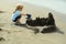 Cute baby boy builds sandcastle on sea beach